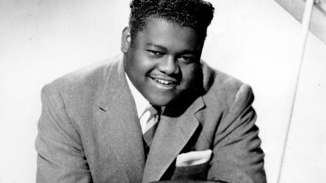 FILE - This 1956 file photo shows singer, composer and pianist Fats Domino.  The amiable rock 'n' roll pioneer whose steady, pounding piano and easy baritone helped change popular music even as it honored the grand, good-humored tradition of the Crescent City, has died. He was 89. Mark Bone, chief investigator with the Jefferson Parish, Louisiana, coroner's office, said Domino died Tuesday, Oct. 25, 2017.  (AP Photo, File)